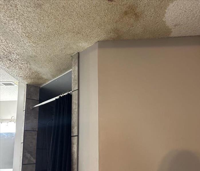 Water damage to the ceiling from a upstairs bathroom