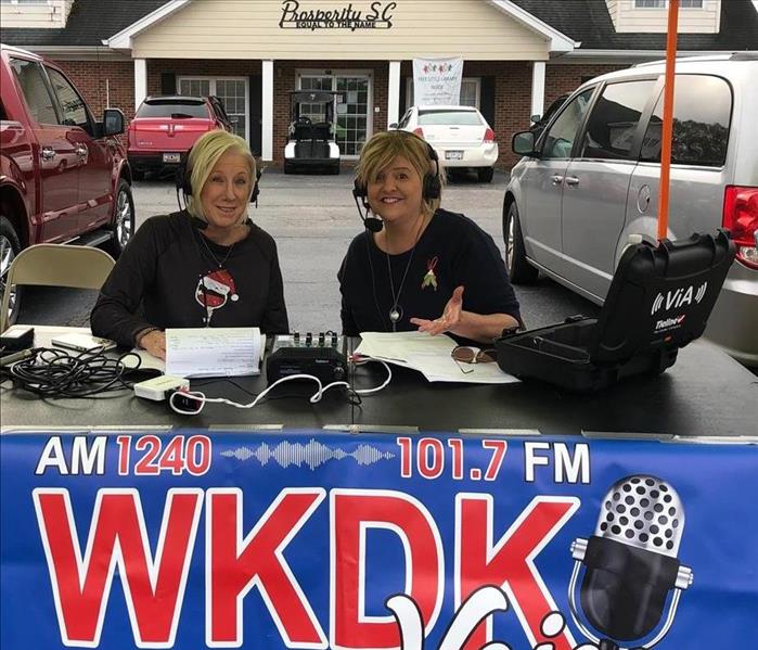 Owner Kimberly Kitchens on the air with WKDK ready to kick off the Prosperity Christmas Parade! 