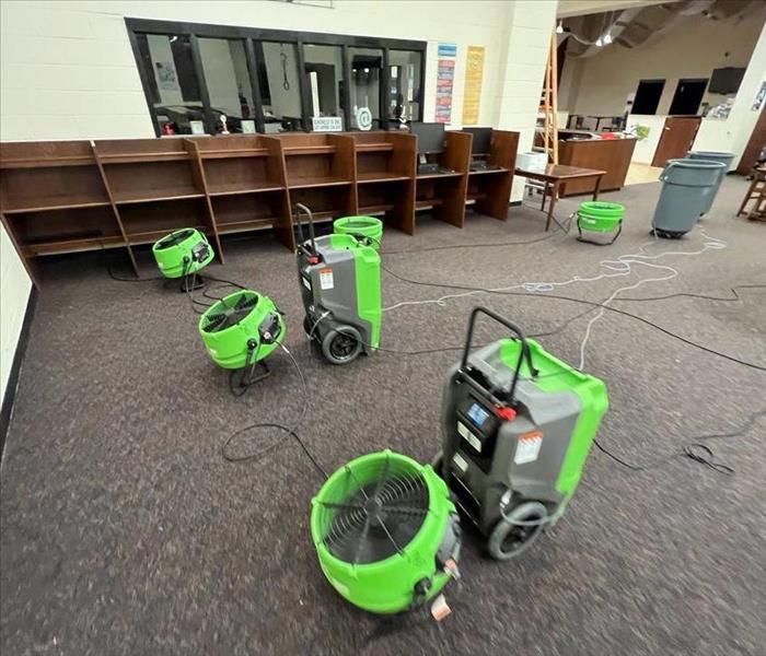 SERVPRO drying units working overtime to dry out the water caused by a pipe busting in the ceiling