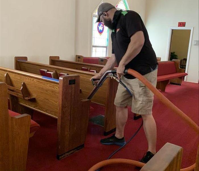 SERVPRO technician cleaning the carepts at a church in Laurens, SC 