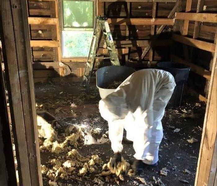 SERVPRO crew member removing fire damaged insulation after a house fire in Newberry, SC
