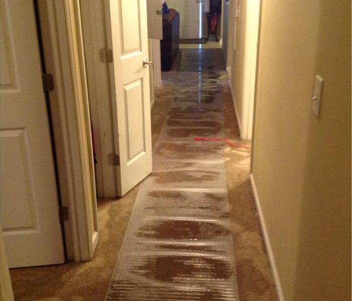 A hallway full of water after a faulty toilet line broke in a home in Clinton, SC 